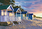 A painting of the huts on Wells beach in evening sunlight by Margaret Heath.