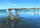 A painting of deck chairs and Brighton Pier in the early morning by Margaret Heath.